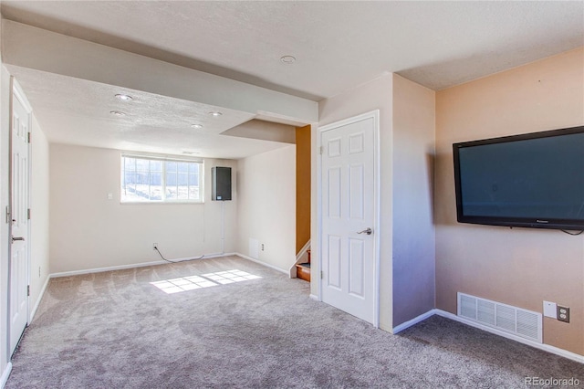 interior space with visible vents, baseboards, stairway, carpet, and a textured ceiling