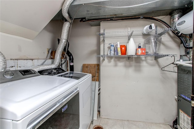 clothes washing area featuring laundry area and washer and clothes dryer