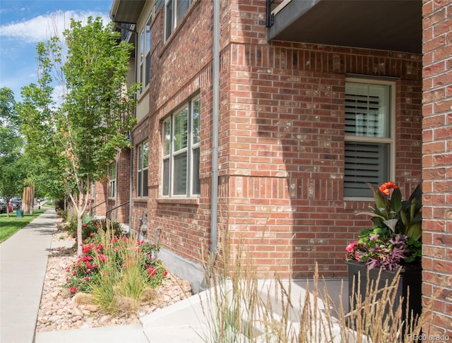 view of side of home featuring brick siding
