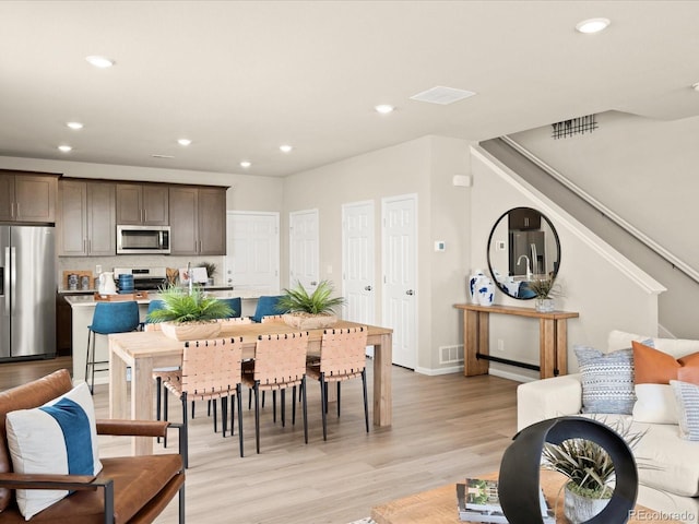 20802 E 66th Ave, Aurora, CO 80019 - dining area featuring light wood-type flooring, recessed lighting, stairs, and baseboards