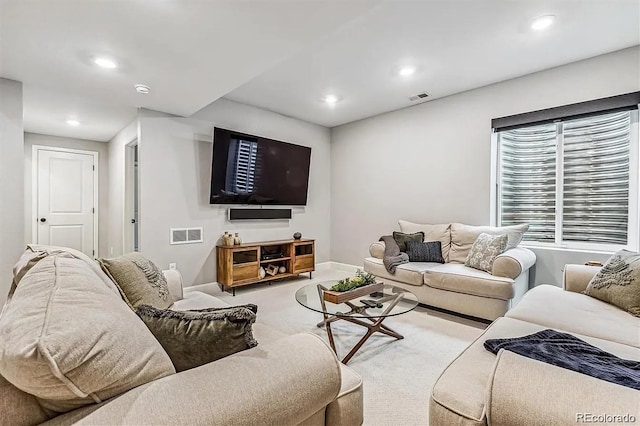 living room with recessed lighting, visible vents, and carpet flooring