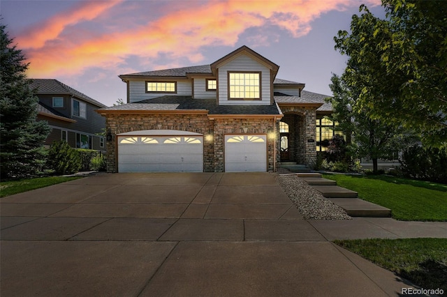 7809 S Coolidge Way, Aurora, CO 80016 - view of front of house featuring concrete driveway, a garage, stone siding, and a front lawn