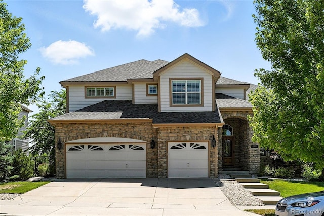 7809 S Coolidge Way, Aurora, CO 80016 - view of front of property with concrete driveway, stone siding, a garage, and a shingled roof