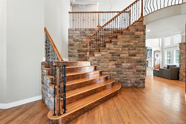 7809 S Coolidge Way, Aurora, CO 80016 - staircase featuring wood finished floors and a towering ceiling