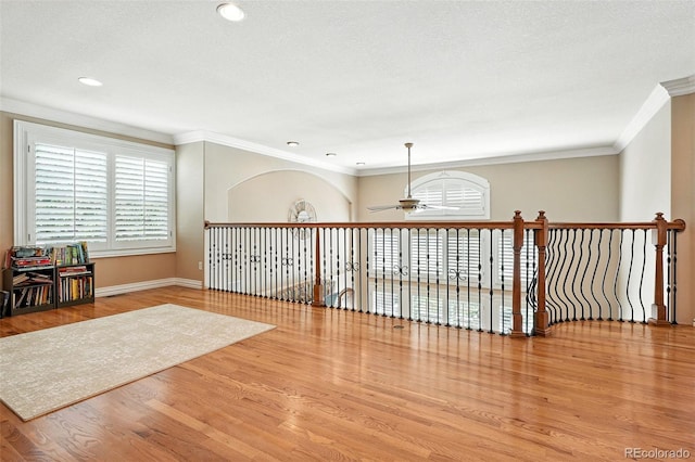 7809 S Coolidge Way, Aurora, CO 80016 - spare room with a ceiling fan, wood finished floors, crown molding, and recessed lighting