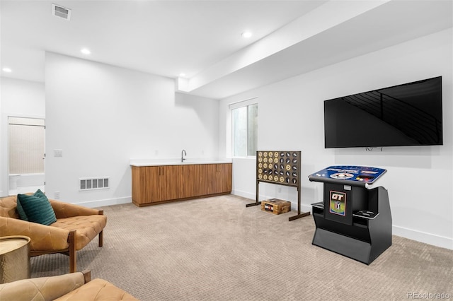 sitting room with recessed lighting, visible vents, light carpet, and baseboards