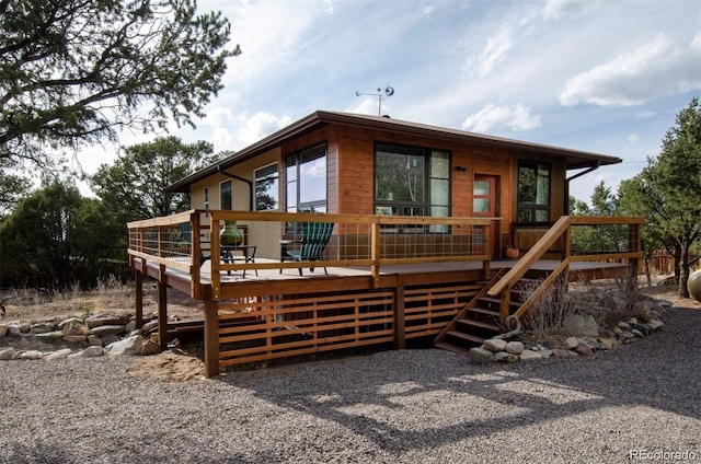 back of property featuring a wooden deck