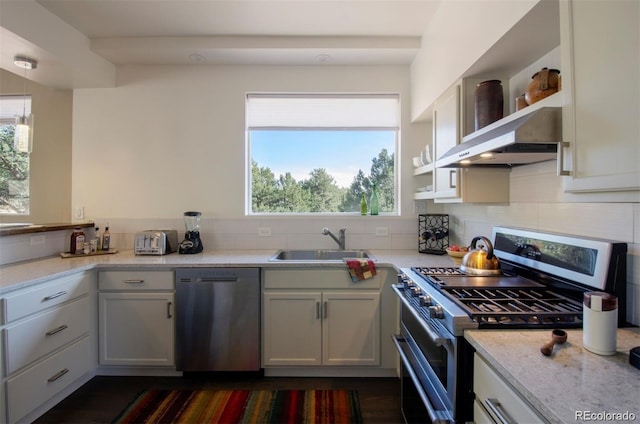 kitchen with stainless steel appliances, plenty of natural light, tasteful backsplash, and sink