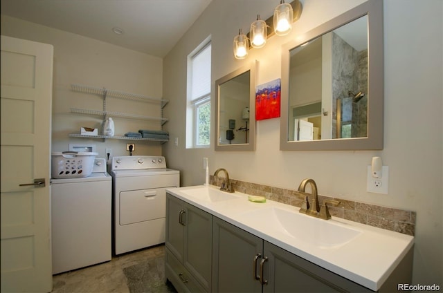 laundry area featuring washing machine and dryer and sink