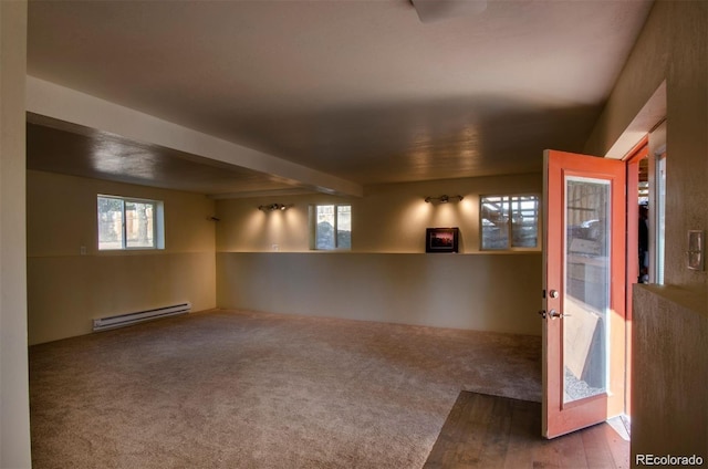 carpeted spare room with a healthy amount of sunlight and a baseboard radiator