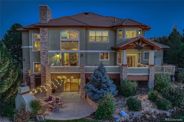 5603 Twilight Way, Parker, CO 80134 - view of front of house with stucco siding, a patio area, a chimney, and a tile roof