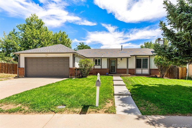 single story home featuring an attached garage, brick siding, fence, driveway, and a front lawn