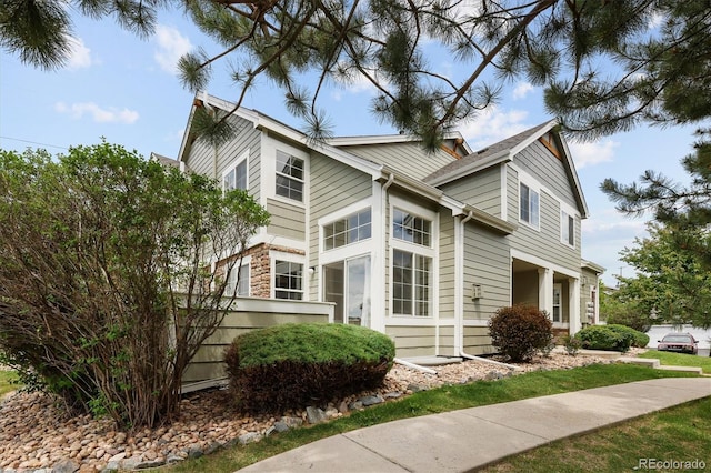 805 Summer Hawk Dr Unit 100, Longmont, CO 80504 - view of side of property featuring stone siding