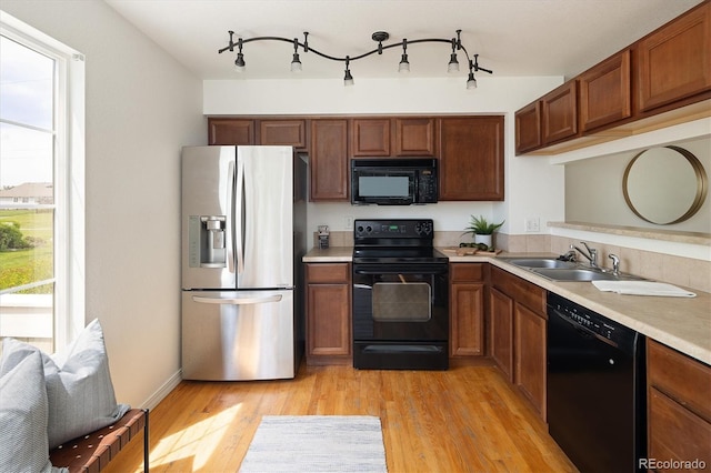 805 Summer Hawk Dr Unit 100, Longmont, CO 80504 - kitchen with black appliances, a sink, light countertops, and healthy amount of natural light
