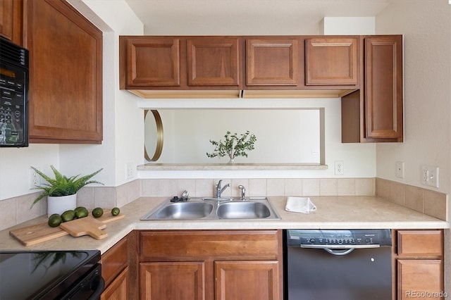 805 Summer Hawk Dr Unit 100, Longmont, CO 80504 - kitchen featuring black appliances, a sink, light countertops, and brown cabinetry