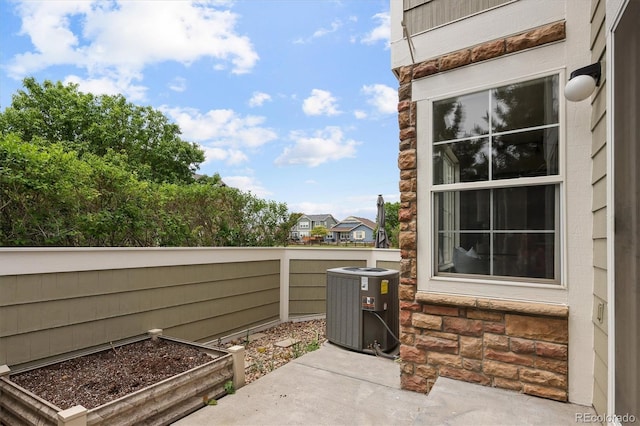 805 Summer Hawk Dr Unit 100, Longmont, CO 80504 - view of patio featuring central air condition unit and a garden