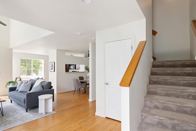 805 Summer Hawk Dr Unit 100, Longmont, CO 80504 - stairs featuring wood finished floors and baseboards