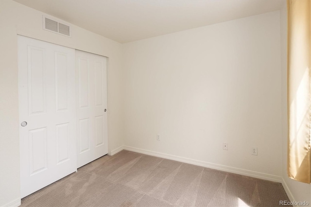 805 Summer Hawk Dr Unit 100, Longmont, CO 80504 - unfurnished bedroom featuring light colored carpet, baseboards, and a closet