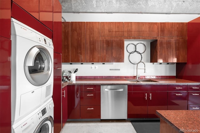 clothes washing area with sink and stacked washer / drying machine