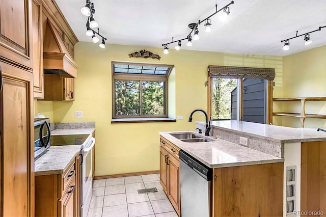 1209 S Flower Cir Unit C, Lakewood, CO 80232 - kitchen with stainless steel appliances, track lighting, premium range hood, a sink, and a center island with sink