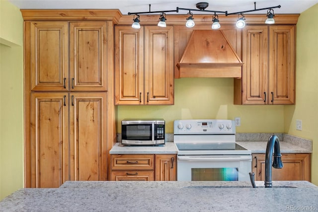 1209 S Flower Cir Unit C, Lakewood, CO 80232 - kitchen featuring white electric range oven, stainless steel microwave, premium range hood, and brown cabinetry