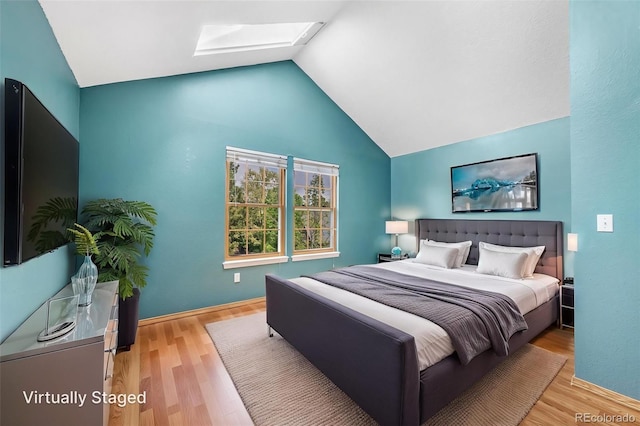 1209 S Flower Cir Unit C, Lakewood, CO 80232 - bedroom featuring a skylight, lofted ceiling, and wood finished floors