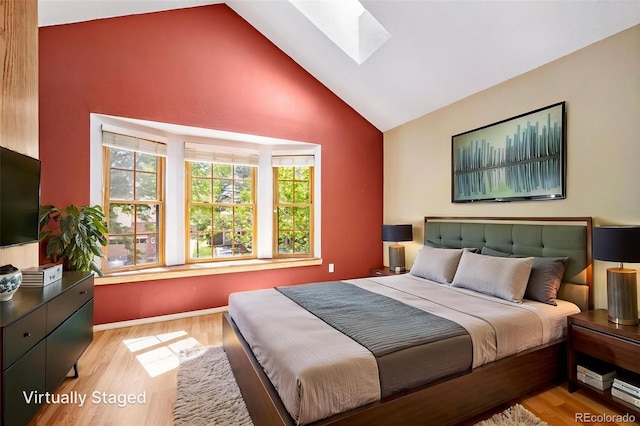 1209 S Flower Cir Unit C, Lakewood, CO 80232 - bedroom with a skylight, high vaulted ceiling, and light wood-style flooring