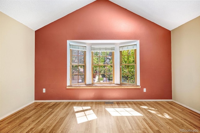 1209 S Flower Cir Unit C, Lakewood, CO 80232 - empty room featuring lofted ceiling, wood finished floors, and baseboards