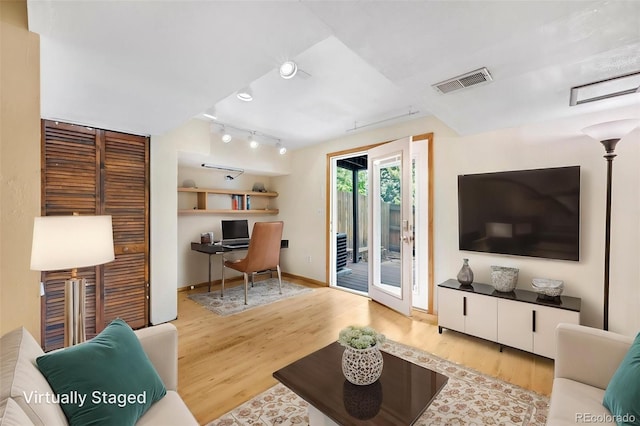 1209 S Flower Cir Unit C, Lakewood, CO 80232 - living room with rail lighting, wood finished floors, a desk, and baseboards