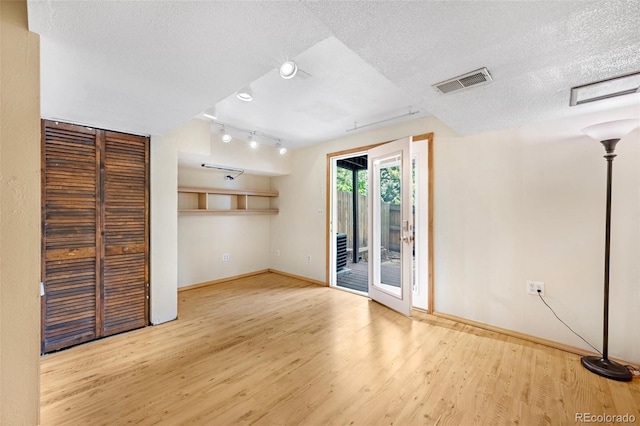 1209 S Flower Cir Unit C, Lakewood, CO 80232 - unfurnished room with a textured ceiling, baseboards, wood finished floors, and rail lighting