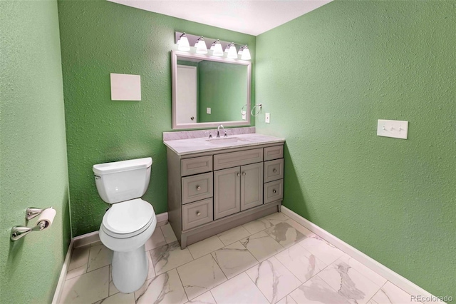 1209 S Flower Cir Unit C, Lakewood, CO 80232 - bathroom featuring toilet, vanity, marble finish flooring, baseboards, and a textured wall