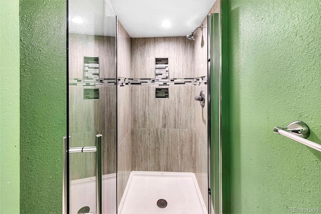 1209 S Flower Cir Unit C, Lakewood, CO 80232 - bathroom featuring a shower stall and a textured wall