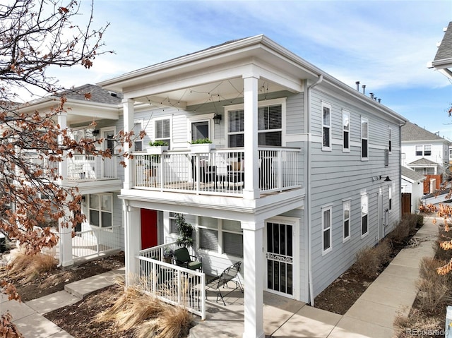 back of house featuring a balcony