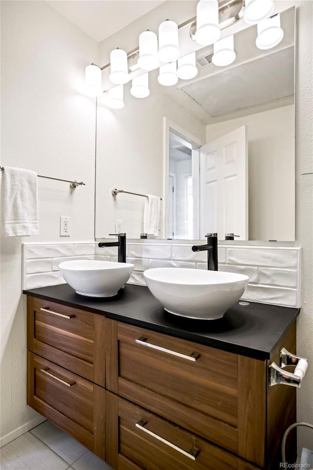 full bath featuring a sink and double vanity