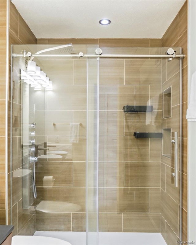 bathroom with a shower stall and toilet