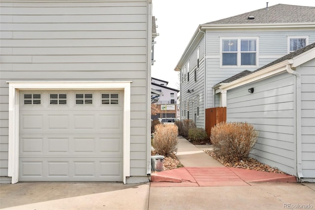 garage featuring concrete driveway