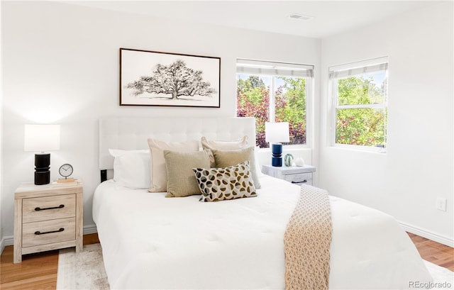 5044 W Moncrieff Pl, Denver, CO 80212 - bedroom featuring light wood-style floors and baseboards