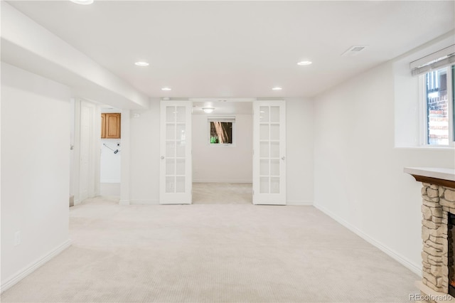 5044 W Moncrieff Pl, Denver, CO 80212 - basement with french doors, light colored carpet, recessed lighting, and a fireplace