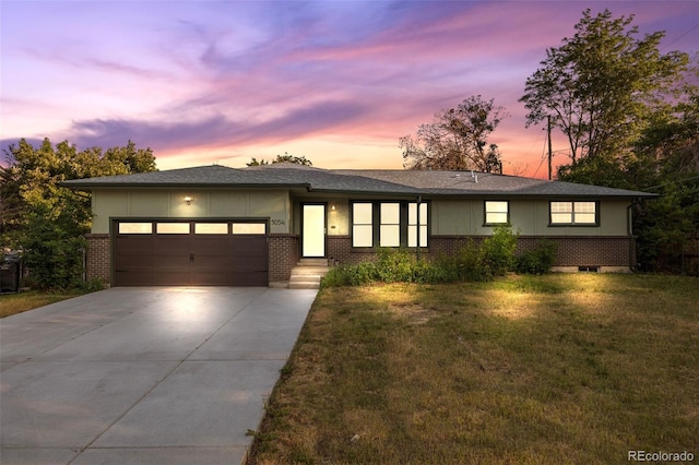 5054 W 61st Dr, Arvada, CO 80003 - view of front of property featuring concrete driveway, a garage, brick siding, a lawn, and board and batten siding