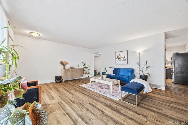 5054 W 61st Dr, Arvada, CO 80003 - living room featuring wood finished floors and a textured ceiling