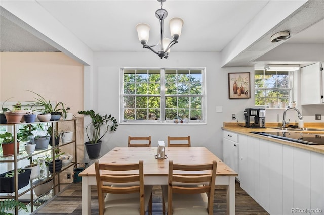 5054 W 61st Dr, Arvada, CO 80003 - dining space featuring dark wood finished floors and a chandelier