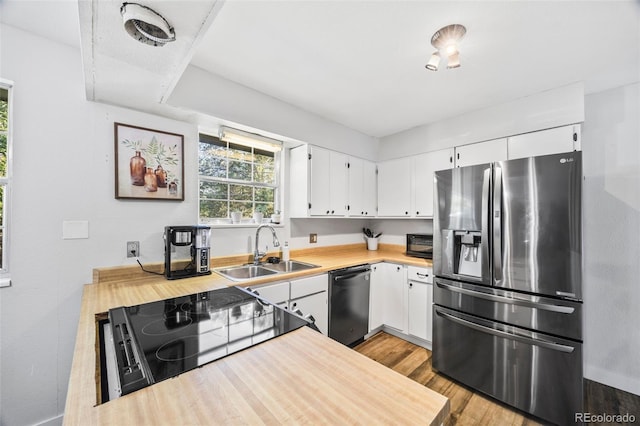 5054 W 61st Dr, Arvada, CO 80003 - kitchen with appliances with stainless steel finishes, light countertops, wood finished floors, and white cabinets