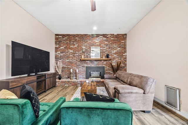 5054 W 61st Dr, Arvada, CO 80003 - living area featuring wood finished floors, ceiling fan, and a brick fireplace