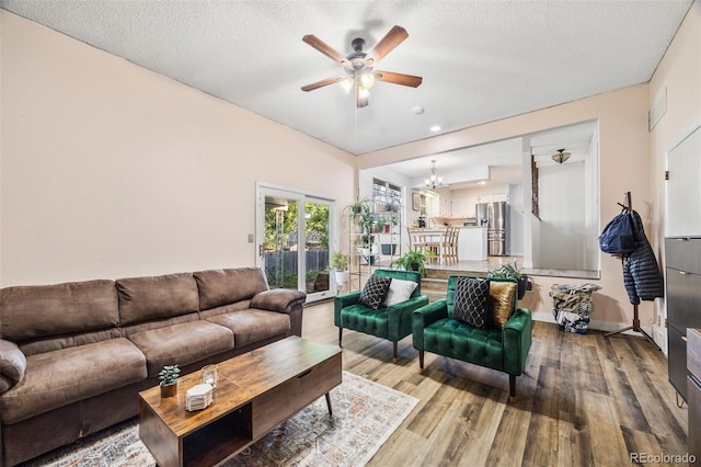 5054 W 61st Dr, Arvada, CO 80003 - living room featuring a ceiling fan, a chandelier, wood finished floors, recessed lighting, and a textured ceiling