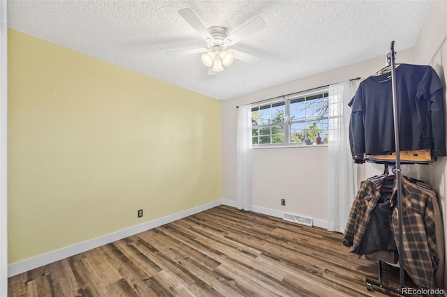 5054 W 61st Dr, Arvada, CO 80003 - unfurnished bedroom with wood finished floors, a textured ceiling, and ceiling fan