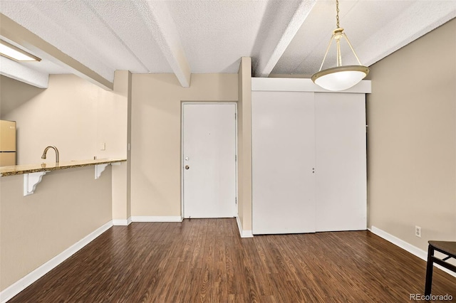 1365 Columbine St Unit 403, Denver, CO 80206 - unfurnished dining area featuring dark wood finished floors and a textured ceiling