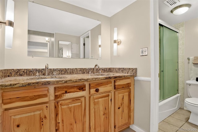 1365 Columbine St Unit 403, Denver, CO 80206 - bathroom featuring tile patterned flooring, double vanity, and shower / bath combination with glass door