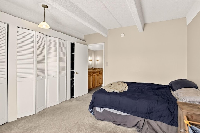 1365 Columbine St Unit 403, Denver, CO 80206 - bedroom with light carpet, beam ceiling, and a textured ceiling