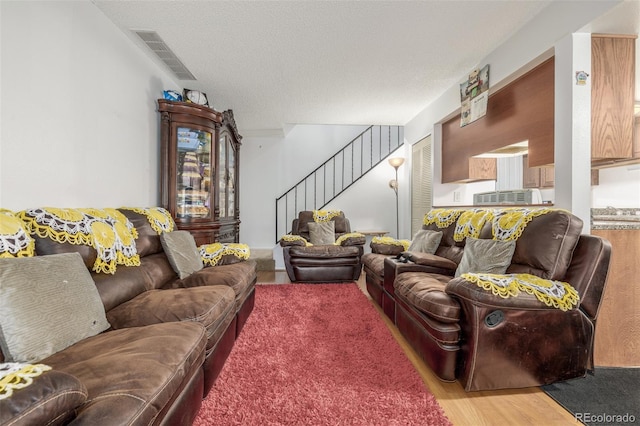 living room featuring hardwood / wood-style flooring and a textured ceiling