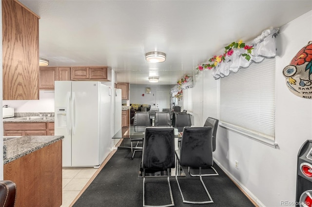 dining space with sink and light tile patterned flooring